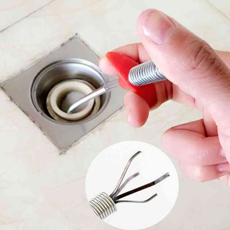 Hand Bending Pressure Sewers Clip Tool To Remove Hair From Drain Pipeline