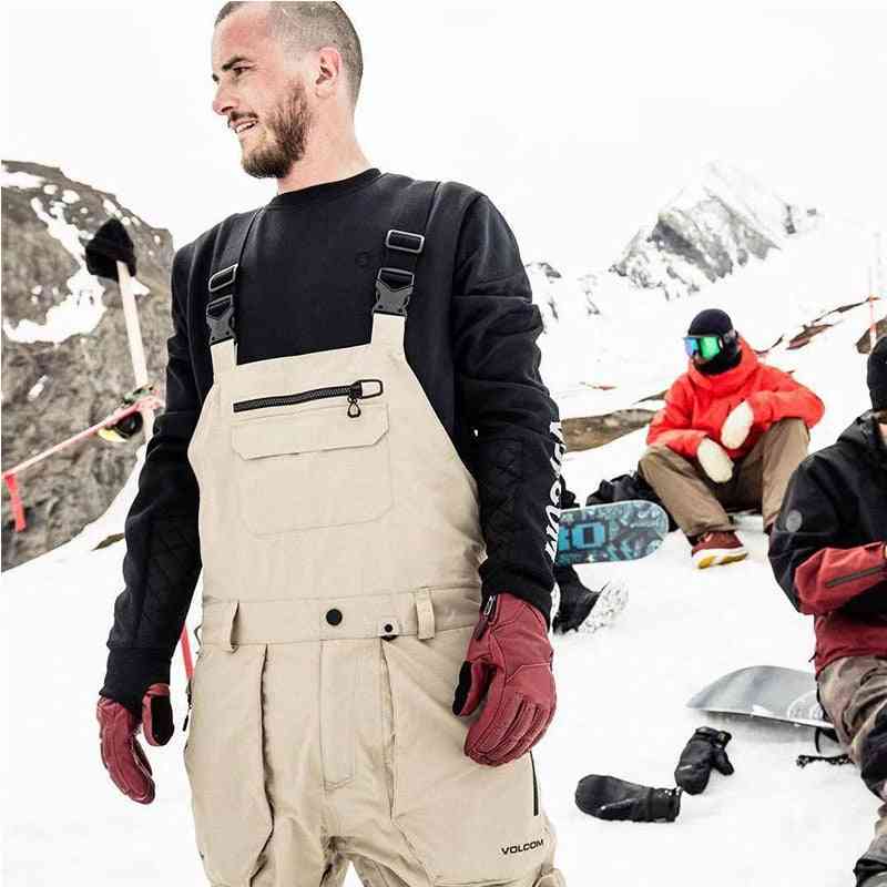 Miesten hiihtohousut hihnoilla mustat khaki vedenpitävät haalarit housut leveät kankaat pitkät housut