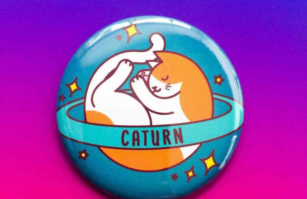 Caturn-planeetta- kissan tappi, magneetti tai peili